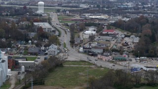 DX0001_003222 - 5.7K aerial stock footage passing a busy street in industrial area near water tower in Lexington, Kentucky