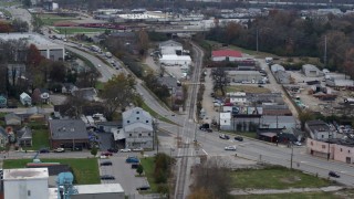 DX0001_003224 - 5.7K aerial stock footage reverse view of a busy street and railroad tracks in industrial area in Lexington, Kentucky
