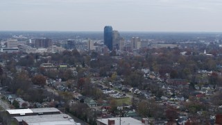 DX0001_003226 - 5.7K aerial stock footage ascend from neighborhood and focus on city skyline, Downtown Lexington, Kentucky