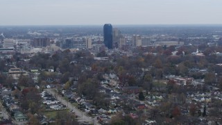 DX0001_003228 - 5.7K aerial stock footage of city skyline while flying by neighborhoods, Downtown Lexington, Kentucky