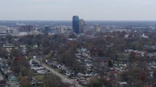 DX0001_003229 - 5.7K aerial stock footage of city skyline while passing by neighborhoods, Downtown Lexington, Kentucky