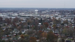 DX0001_003236 - 5.7K aerial stock footage of a water tower surrounded by warehouse buildings in Lexington, Kentucky