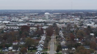 DX0001_003237 - 5.7K aerial stock footage of a tall water tower surrounded by warehouse buildings in Lexington, Kentucky