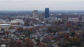DX0001_003244 - 5.7K aerial stock footage of flying by skyscrapers in the city skyline, seen from neighborhoods, Downtown Lexington, Kentucky