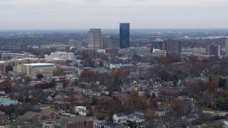 DX0001_003245 - 5.7K aerial stock footage of passing by skyscrapers in the city skyline, seen from neighborhoods, Downtown Lexington, Kentucky
