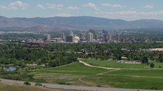 DX0001_004_007 - 5.7K aerial stock footage of a view of the distant city skyline, seen from a park in Reno, Nevada