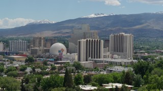 DX0001_004_009 - 5.7K aerial stock footage of hotels and casinos with mountains in the distance in Reno, Nevada