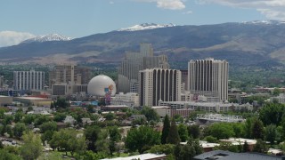 DX0001_004_010 - 5.7K aerial stock footage of a view of hotels and casinos with mountains in the distance in Reno, Nevada
