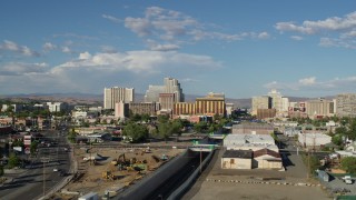 DX0001_005_001 - 5.7K aerial stock footage of following train tracks toward casino resorts in Reno, Nevada