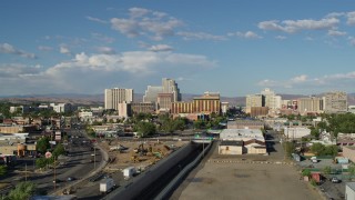 DX0001_005_003 - 5.7K aerial stock footage of following train tracks toward the city skyline in Reno, Nevada