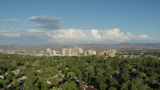 DX0001_005_007 - 5.7K aerial stock footage of ascending from Lake Park to reveal the city skyline in Reno, Nevada