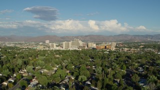 DX0001_005_008 - 5.7K aerial stock footage of a view of the city skyline from tree-lined neighborhoods in Reno, Nevada