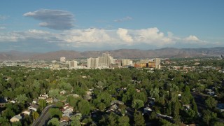 DX0001_005_009 - 5.7K aerial stock footage of the city skyline seen from tree-lined neighborhoods in Reno, Nevada