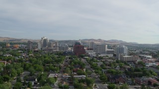 DX0001_006_021 - 5.7K aerial stock footage reverse view of casino resorts and office buildings seen from neighborhood in Reno, Nevada