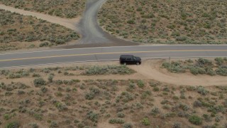 DX0001_007_023 - 5.7K stock footage aerial video track a black SUV as it turns and drives in the opposite direction in Carson City, Nevada