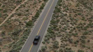 DX0001_007_031 - 5.7K stock footage aerial video of revealing a black truck driving on a desert road in Carson City, Nevada