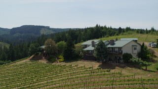 DX0001_009_018 - 5.7K aerial stock footage of a hilltop home overlooking Phelps Creek Vineyards in Hood River, Oregon