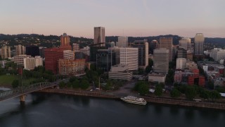 DX0001_010_004 - 4K aerial stock footage flying by the downtown skyline, Hawthorne Bridge at sunrise, Downtown Portland, Oregon