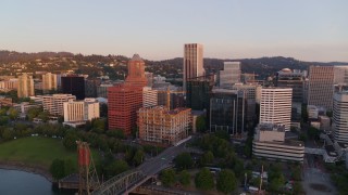 DX0001_010_012 - 4K aerial stock footage approaching downtown buildings, passing the Hawthorne Bridge at sunrise, Downtown Portland, Oregon