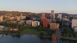DX0001_010_014 - 4K aerial stock footage flying by downtown near Riverplace Marina at sunrise, Downtown Portland, Oregon
