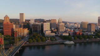 DX0001_010_017 - 4K aerial stock footage flying away from Downtown and toward the Hawthorne Bridge at sunrise, Downtown Portland, Oregon
