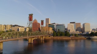 DX0001_010_023 - 4K aerial stock footage flying over Hawthorne Bridge, approaching waterfront park and Downtown Portland, Oregon at sunrise