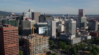 DX0001_011_007 - 5.7K aerial stock footage flying away from downtown buildings, skyscrapers and construction crane, Downtown Portland, Oregon