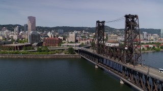DX0001_012_001 - 5.7K aerial stock footage flying by Steel Bridge and revealing waterfront apartment buildings, Downtown Portland, Oregon