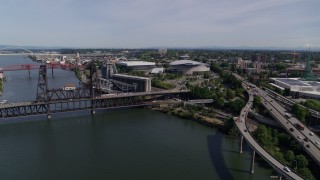DX0001_012_005 - 5.7K aerial stock footage of the Steel Bridge spanning the Willamette River near Moda Center arena, Northeast Portland, Oregon