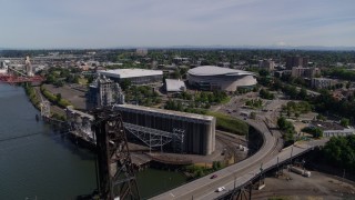 DX0001_012_006 - 5.7K aerial stock footage of Moda Center and Veterans Memorial Coliseum from Steel Bridge, Northeast Portland, Oregon