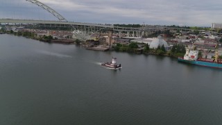 DX0001_013_005 - 5.7K aerial stock footage of a tugboat in the river, North Portland, Oregon