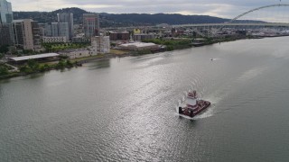 DX0001_013_007 - 5.7K aerial stock footage tracking a tugboat and revealing Fremont Bridge, Downtown Portland, Oregon
