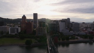 DX0001_014_003 - 5.7K aerial stock footage of the setting sun behind the downtown skyline, sunset, Downtown Portland, Oregon