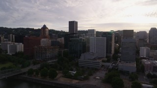 DX0001_014_004 - 5.7K aerial stock footage of approaching office buildings near the river at sunset, Downtown Portland, Oregon