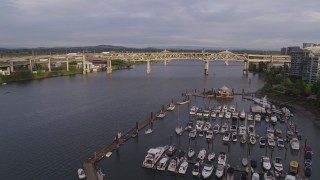 DX0001_014_006 - 5.7K aerial stock footage fly over marina toward bridges, sunset, South Portland, Oregon