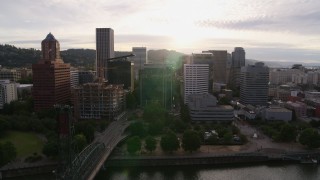 DX0001_014_010 - 5.7K aerial stock footage of skyscrapers and office buildings near the Willamette River at sunset, Downtown Portland, Oregon