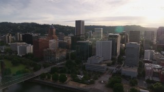 DX0001_014_011 - 5.7K aerial stock footage of downtown office buildings near the river at sunset, Downtown Portland, Oregon