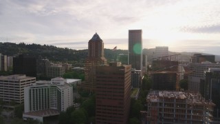 DX0001_014_012 - 5.7K aerial stock footage of city buildings near the river at sunset, Downtown Portland, Oregon