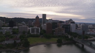 DX0001_014_015 - 5.7K aerial stock footage approaching the KOIN Center and Marriott Hotel from the Willamette River, sunset, Downtown Portland, Oregon