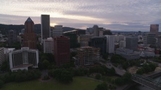 DX0001_014_018 - 5.7K aerial stock footage flying away from Downtown Portland office buildings and hotel at twilight, Oregon
