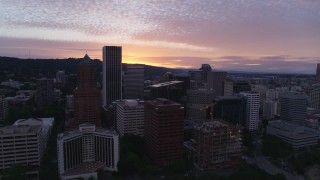 DX0001_014_029 - 5.7K aerial stock footage of flying away from skyscrapers and waterfront park in Downtown Portland, Oregon, twilight
