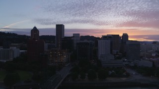 DX0001_014_033 - 5.7K aerial stock footage flying by a bridge with a view of Downtown Portland, Oregon at twilight