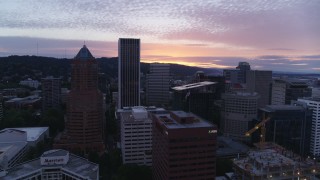 DX0001_014_034 - 5.7K aerial stock footage flying by office buildings and skyscrapers in Downtown Portland, Oregon at sunset