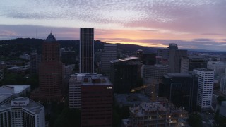 DX0001_014_035 - 5.7K aerial stock footage orbiting tall skyscrapers in Downtown Portland, Oregon at twilight