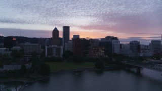 DX0001_014_037 - 5.7K aerial stock footage descending across the river with a view of Downtown Portland, Oregon at twilight