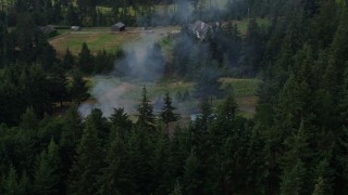 DX0001_015_027 - 5.7K aerial stock footage orbit a fire near rural homes in Hood River, Oregon