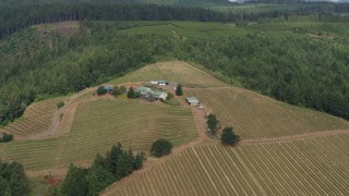 DX0001_016_004 - 5.7K aerial stock footage of a wide orbit of a winery and vineyards on a hilltop in Hood River, Oregon
