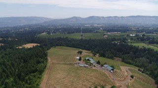 DX0001_017_035 - 5.7K aerial stock footage of descending toward hilltop buildings and grapevines at Phelps Creek Vineyards in Hood River, Oregon
