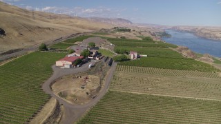 DX0001_018_011 - 5.7K aerial stock footage of a reverse view of the Maryhill Winery and vineyards beside the Columbia River in Goldendale, Washington