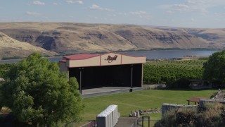 DX0001_018_021 - 5.7K aerial stock footage flying over stage at the Maryhill Winery to approach Columbia River in Goldendale, Washington